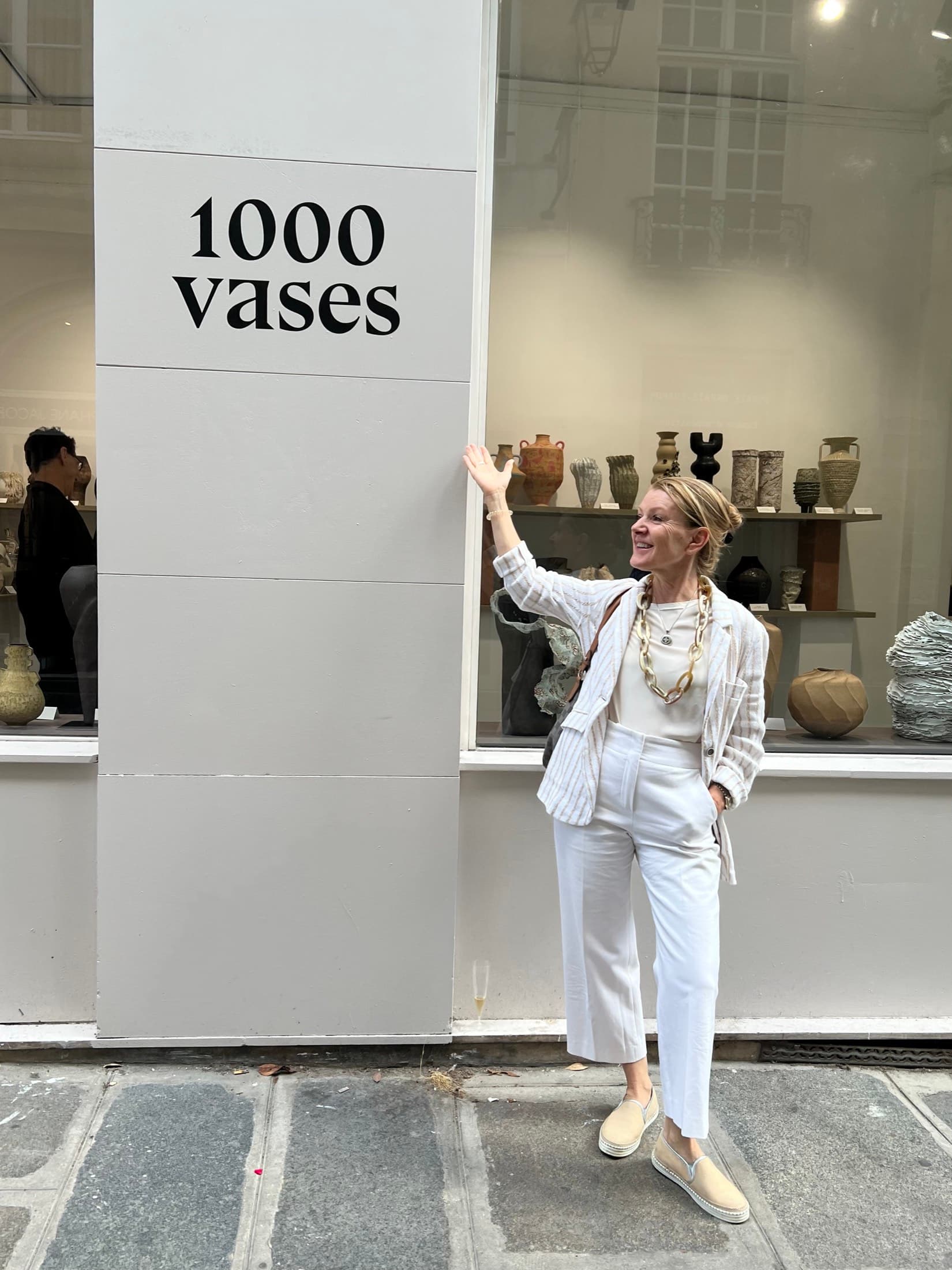 Lucia Munuera outside the window of the 1000 Vases exhibition